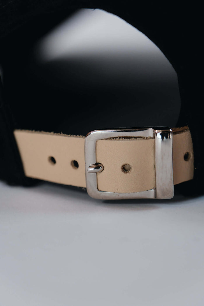 Black suede baseball cap buckle detail by Éclectique