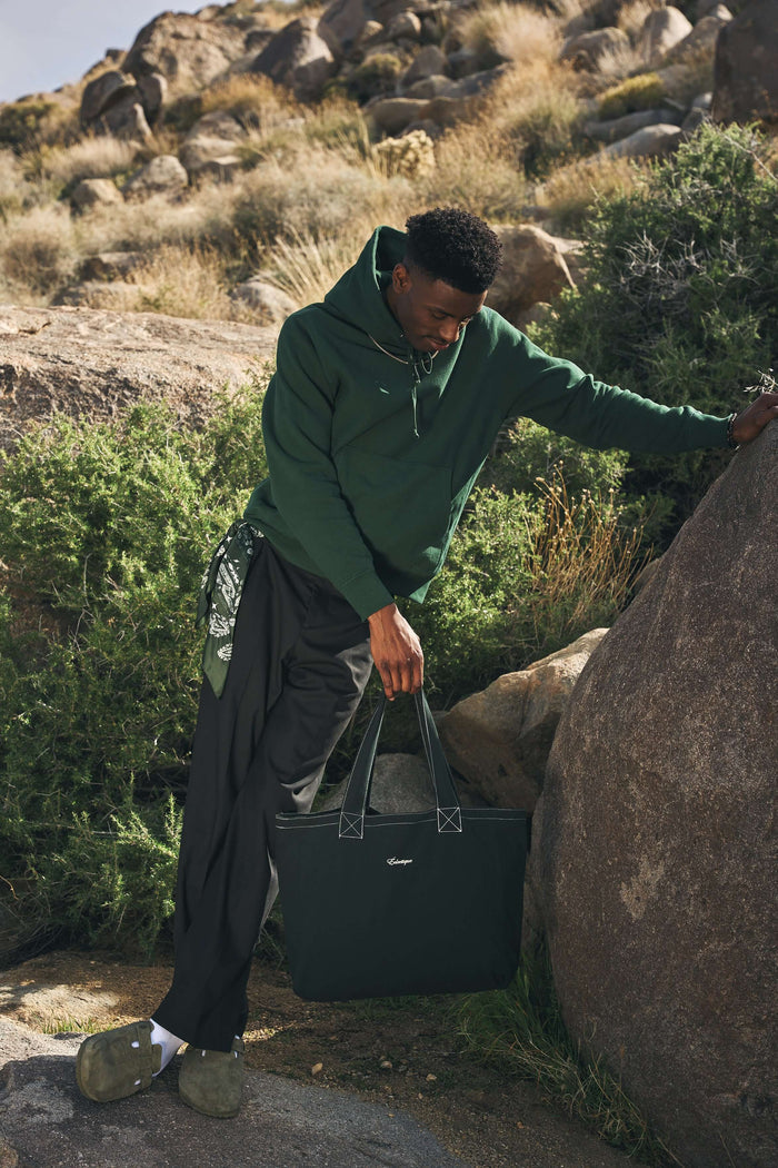 Éclectique scarab green canvas tote bag held by model
