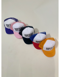 A series of baseball caps displayed in a row with the text 'DON'T PET THE LOCALS' on them. The caps are in a line with colors red, pink, blue, white, yellow, and green.