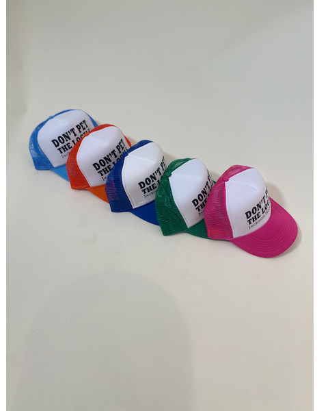 don't pet the locals trucker hats in light blue, orange, royal blue, green and pink