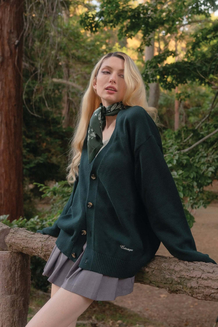Female model in green v neck cardigan in Scarab green outdoors