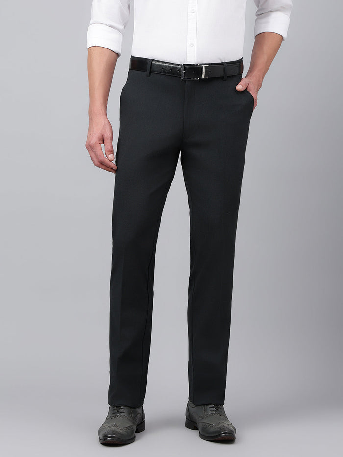 A man wearing a pair of dark grey standard fit formal trousers with a white shirt and black belt.