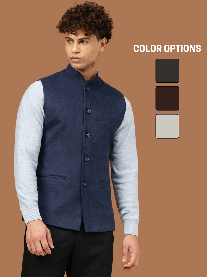 Man wearing a navy blue Nehru jacket with a mandarin collar over a light grey shirt