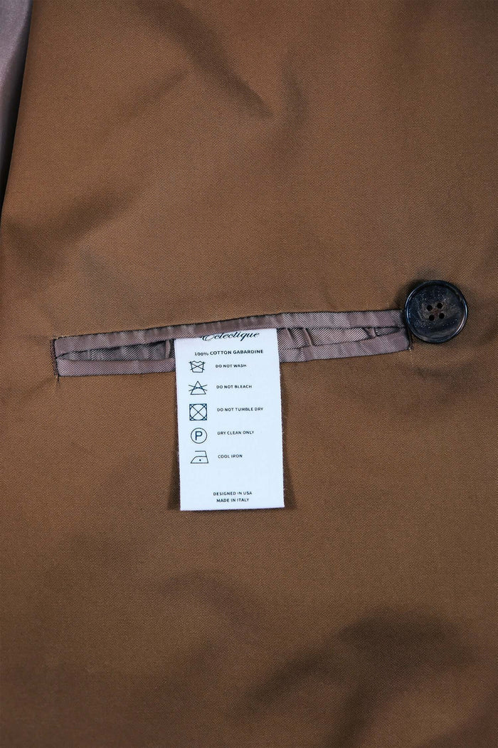 Interior label of Men’s Camel Trench Coat – Manny with care instructions and button detail.
