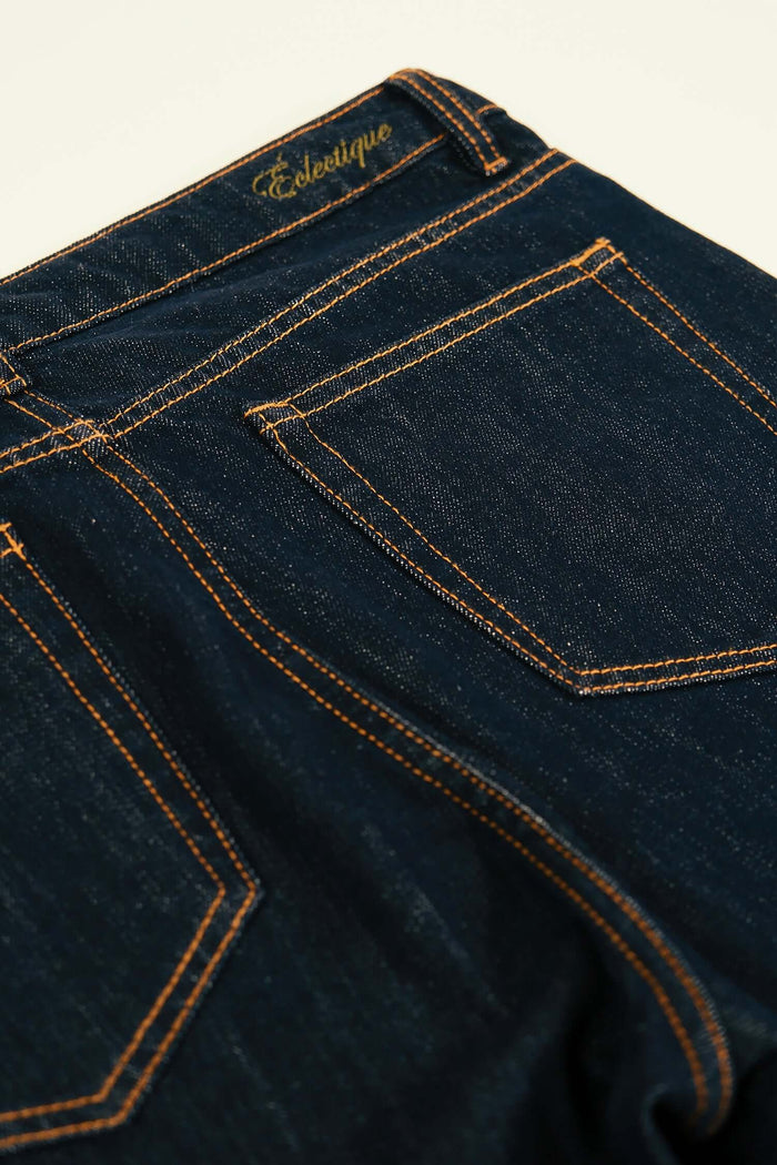 Men's premium denim jeans with a dark navy blue wash, showcasing the back pockets and branding detail.