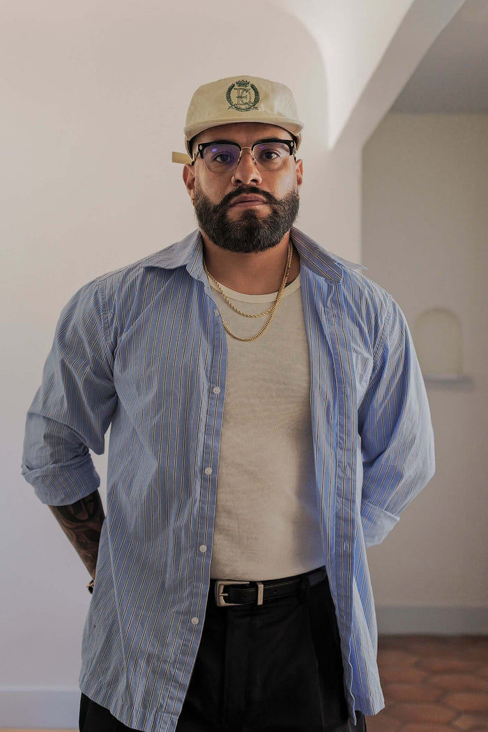 Man wearing a men's striped casual shirt in lightweight cotton, paired with casual attire and accessories.