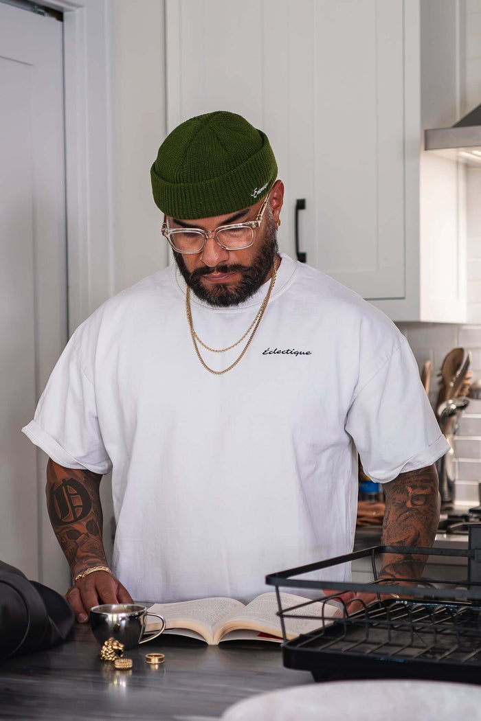 Sedona graphic T-shirt worn by a man reading in a kitchen, showcasing a relaxed fit and stylish design.